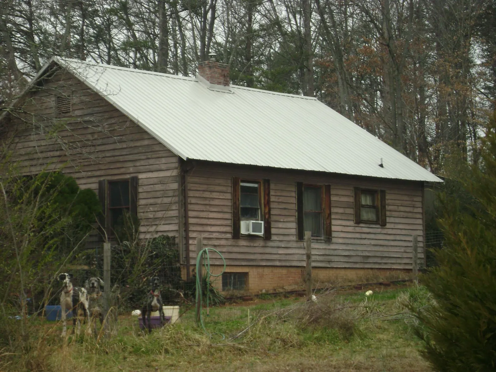White metal roof on an old wood sided farmhouse, from a Metal Roof Installation job in Ellis